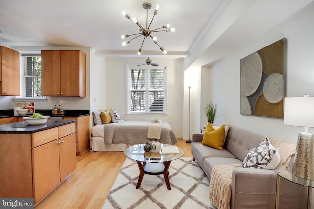 bedroom with an inviting chandelier, light wood-style flooring, and ornamental molding