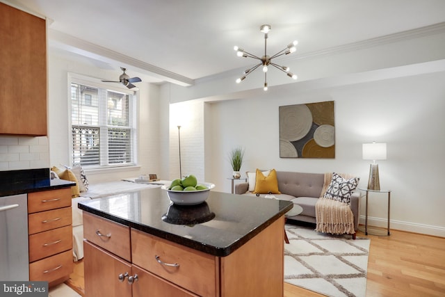 kitchen featuring ornamental molding, light wood-type flooring, open floor plan, and brown cabinets