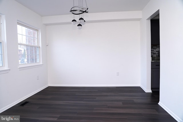 unfurnished room with dark hardwood / wood-style flooring