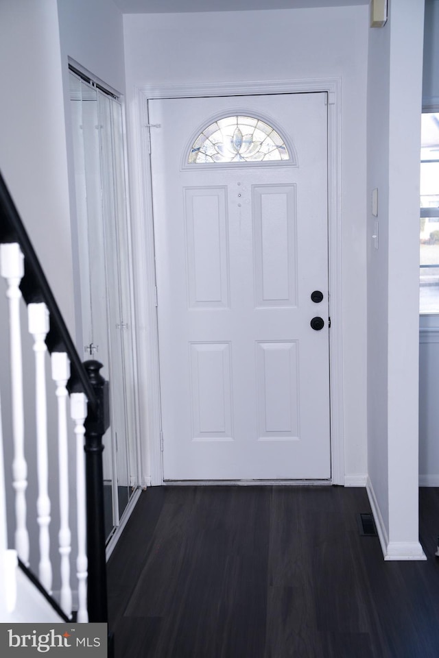 entryway with dark hardwood / wood-style flooring