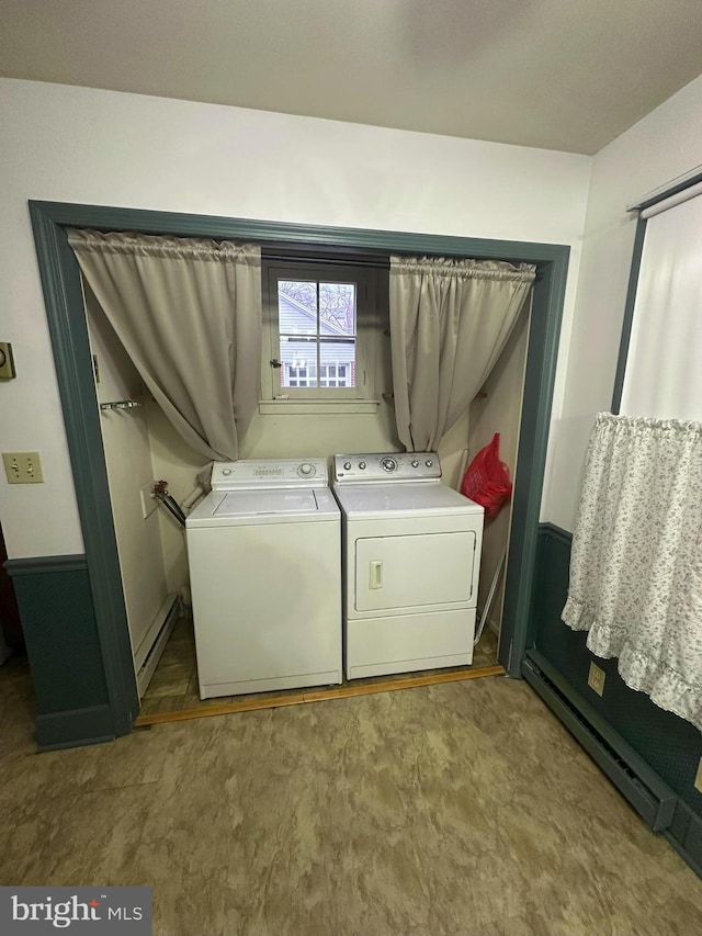 washroom featuring baseboard heating and separate washer and dryer