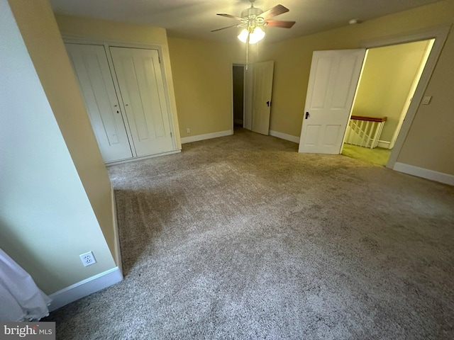 unfurnished bedroom with ceiling fan and carpet