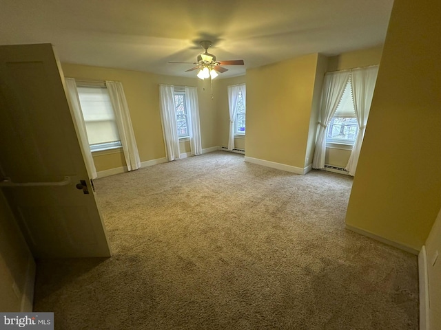 carpeted empty room featuring ceiling fan and a healthy amount of sunlight