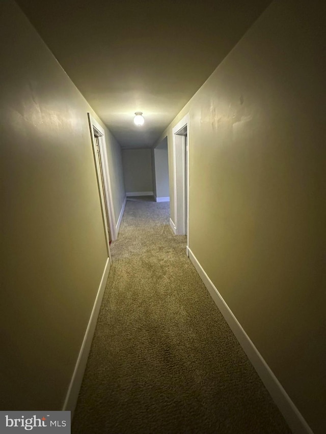 hall with light colored carpet