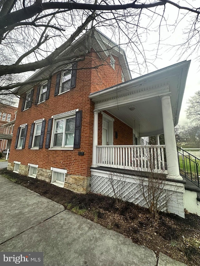 view of property exterior with covered porch