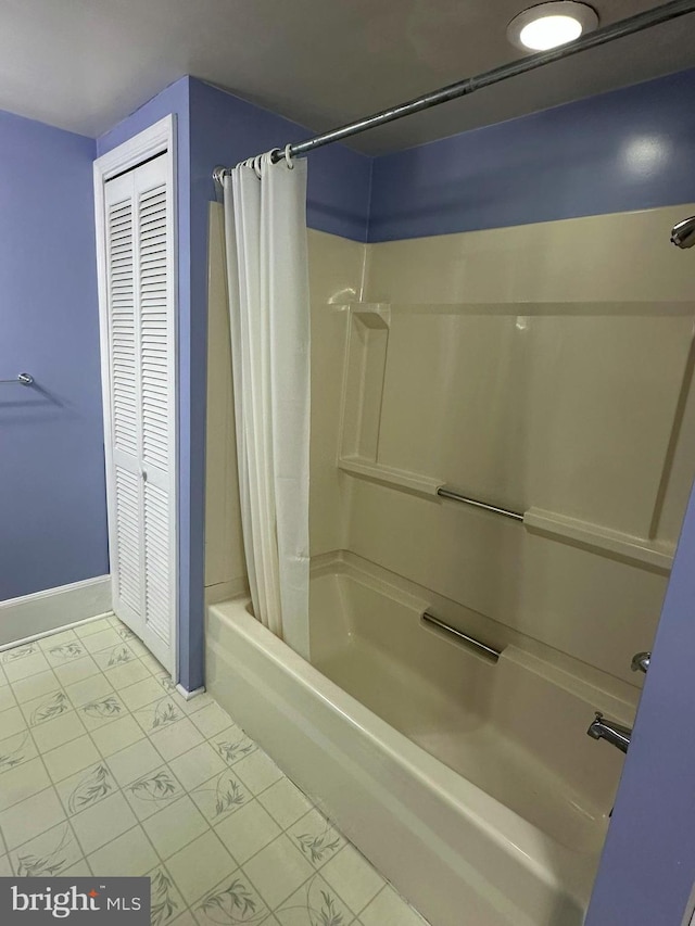 bathroom featuring shower / bath combo with shower curtain and tile patterned flooring