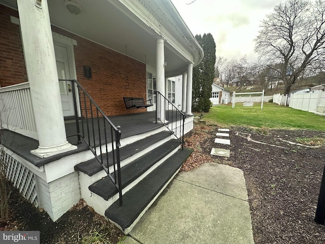 view of property exterior featuring covered porch and a yard