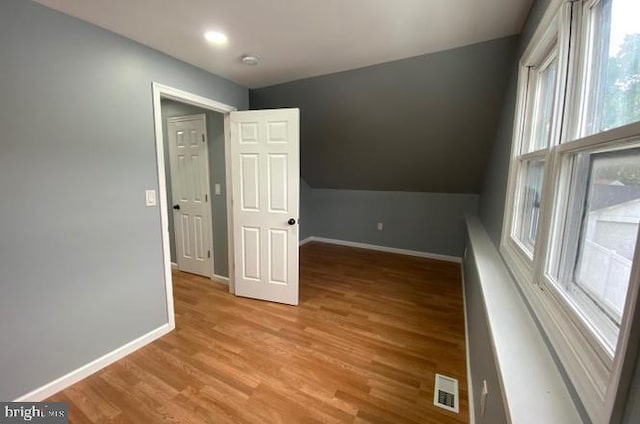 additional living space featuring light hardwood / wood-style floors