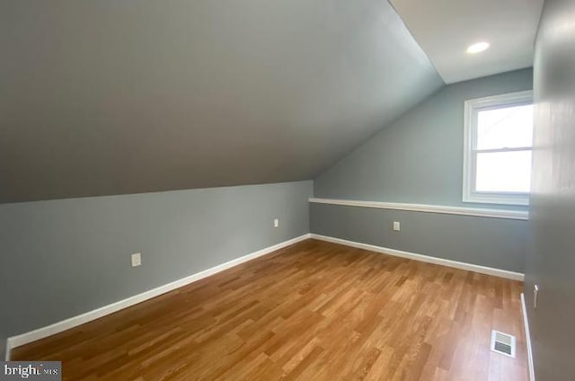 bonus room featuring light hardwood / wood-style floors and vaulted ceiling