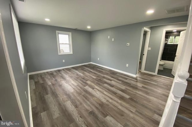 unfurnished room with dark wood-type flooring