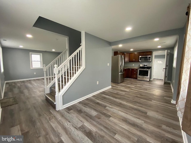 kitchen featuring dark hardwood / wood-style flooring, dark brown cabinetry, and appliances with stainless steel finishes