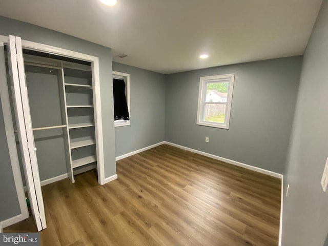 unfurnished bedroom featuring a closet and wood-type flooring