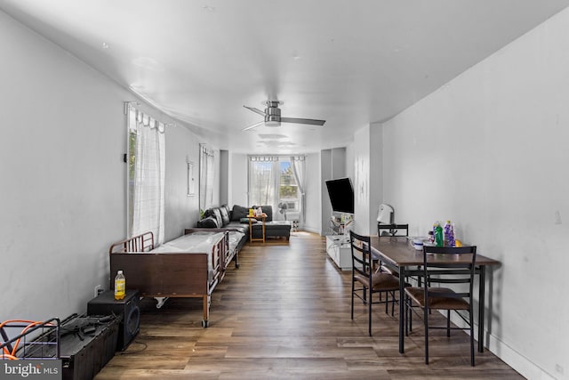 living room with dark hardwood / wood-style floors and ceiling fan