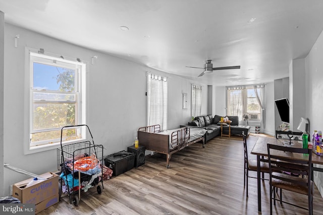 living room with light wood-type flooring and ceiling fan