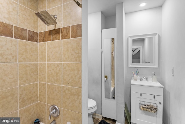 full bathroom with vanity, toilet, and tiled shower / bath combo