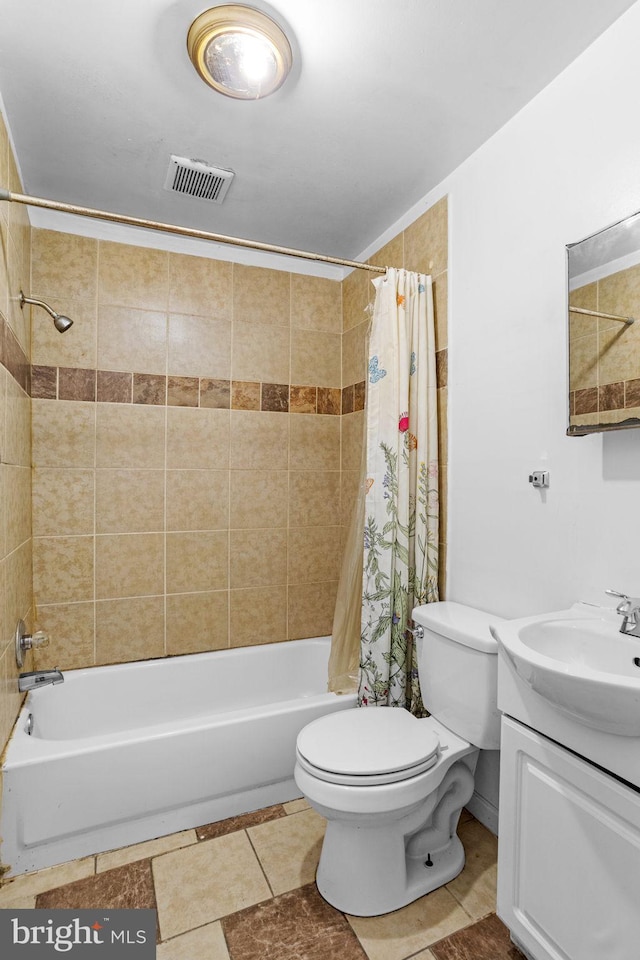 full bathroom with tile patterned flooring, shower / bath combination with curtain, vanity, and toilet