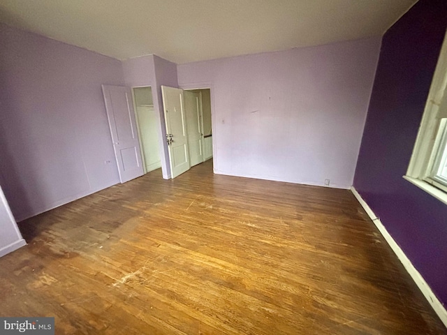 unfurnished bedroom with hardwood / wood-style floors