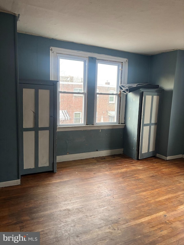 spare room featuring dark hardwood / wood-style flooring