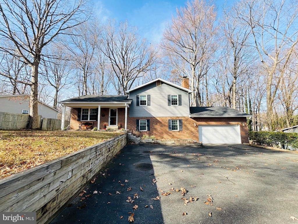 tri-level home with a porch and a garage