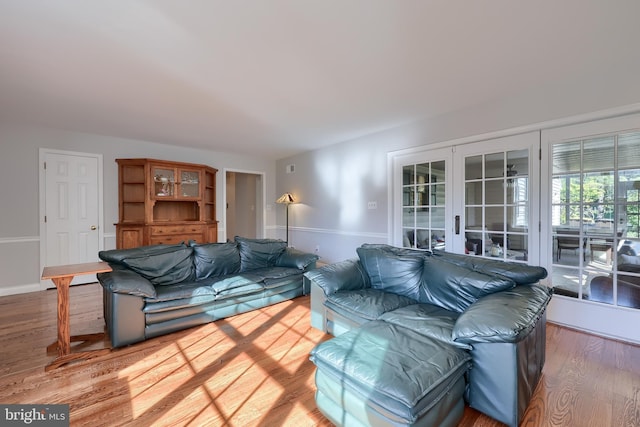 living room with french doors and hardwood / wood-style flooring