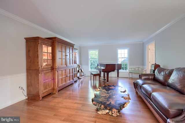 living room featuring light wood-type flooring and ornamental molding