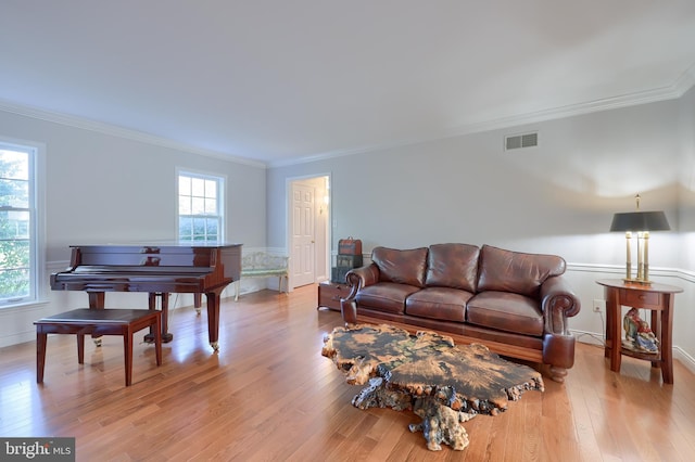 living room featuring light hardwood / wood-style flooring and ornamental molding