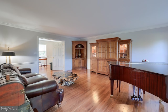 living room with light hardwood / wood-style flooring and ornamental molding