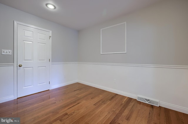 spare room with wood-type flooring