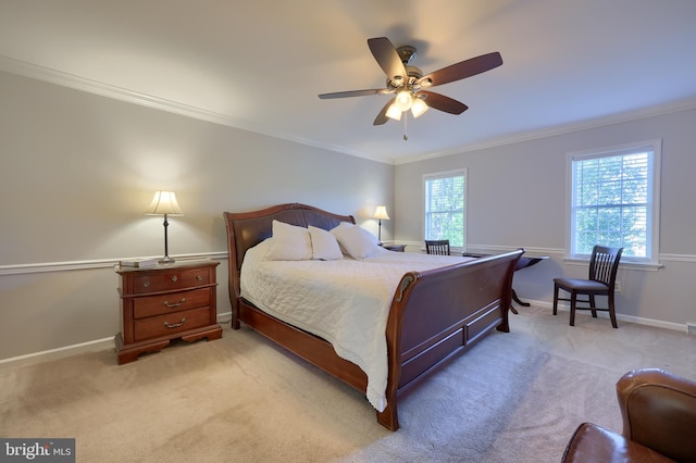 carpeted bedroom with ceiling fan and crown molding