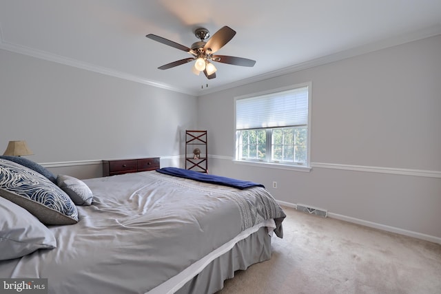 carpeted bedroom featuring ceiling fan and ornamental molding