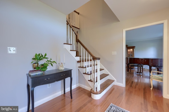 stairs featuring hardwood / wood-style flooring