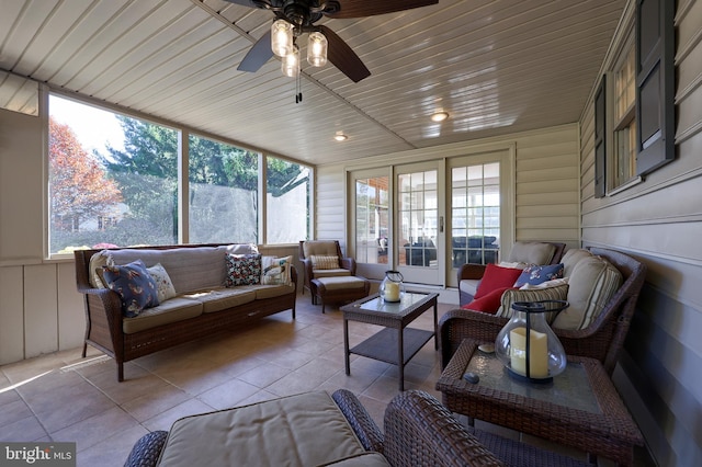 sunroom with ceiling fan, wood ceiling, and a wealth of natural light