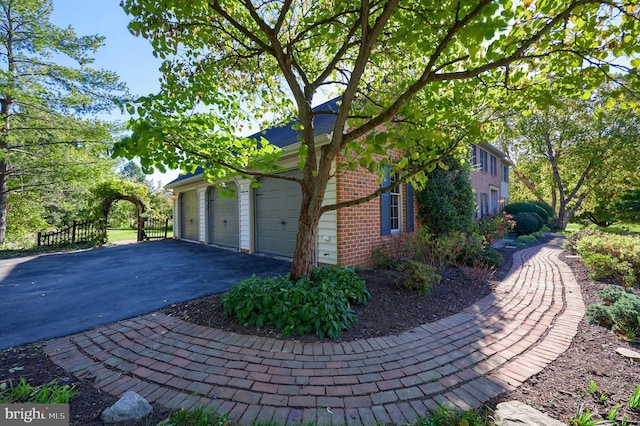 view of side of home featuring a garage