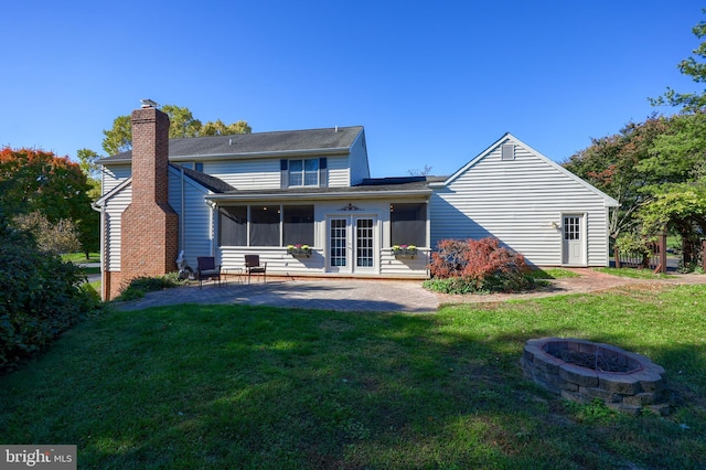 back of house featuring french doors, a yard, an outdoor fire pit, and a patio area