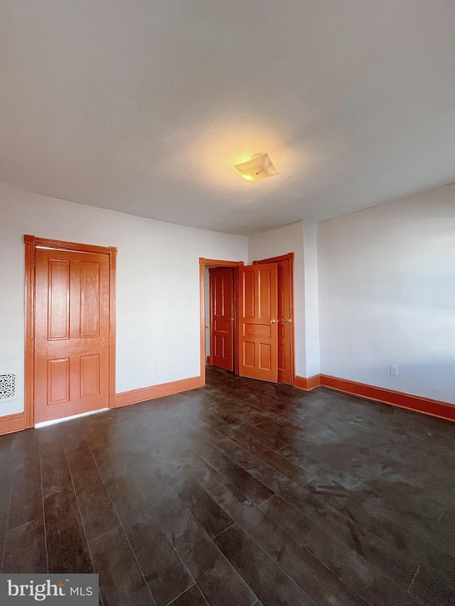 spare room featuring dark hardwood / wood-style floors