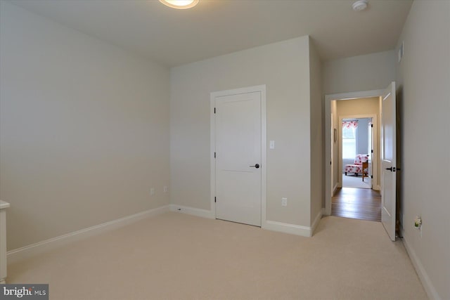 unfurnished bedroom featuring light carpet