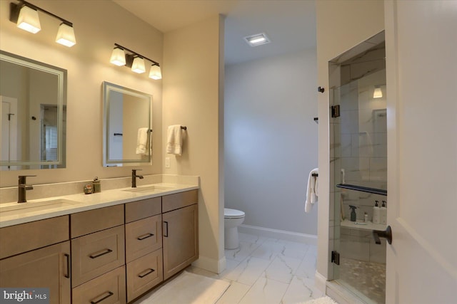 bathroom with vanity, a shower with shower door, and toilet