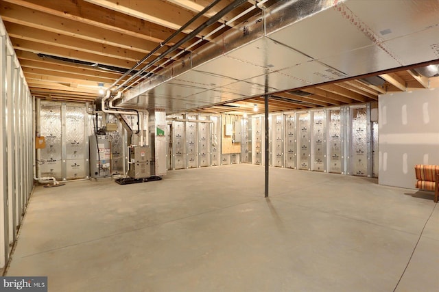 basement featuring heating unit and water heater