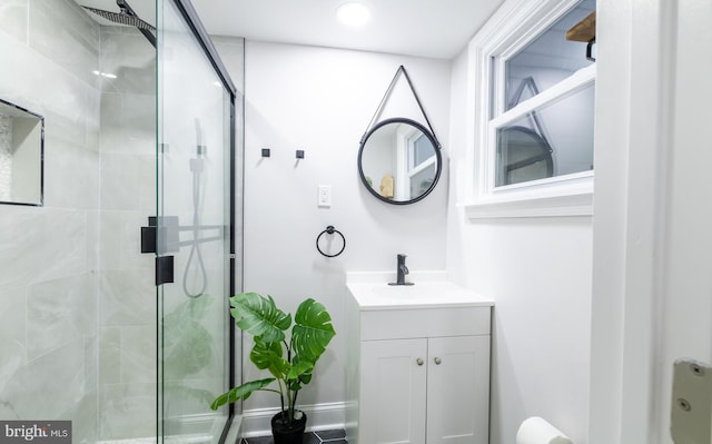 bathroom featuring vanity and a shower with door