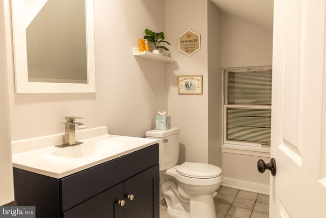 bathroom with tile patterned flooring, vanity, and toilet