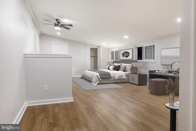 bedroom with hardwood / wood-style floors, ceiling fan, and lofted ceiling