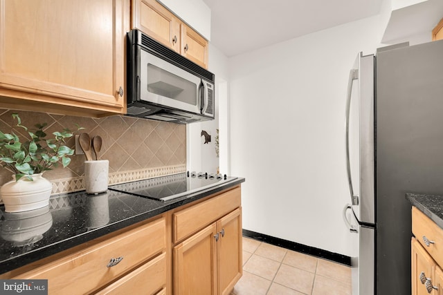 kitchen with decorative backsplash, light brown cabinets, black stovetop, stainless steel refrigerator, and light tile patterned flooring