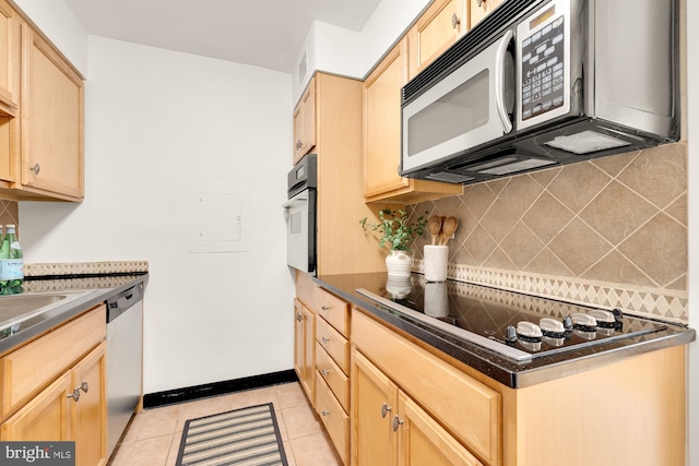 kitchen featuring backsplash, light tile patterned flooring, stainless steel appliances, and light brown cabinetry