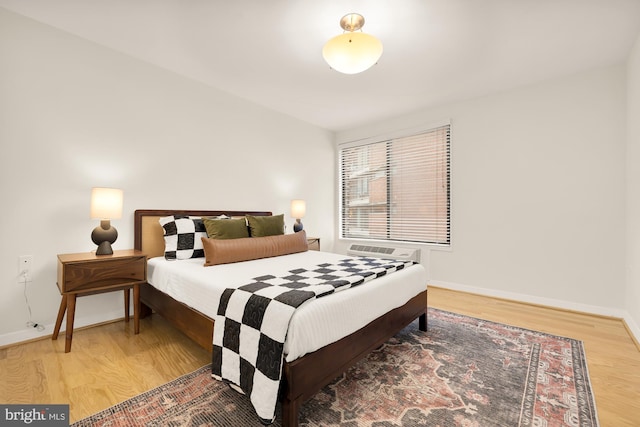 bedroom with hardwood / wood-style flooring