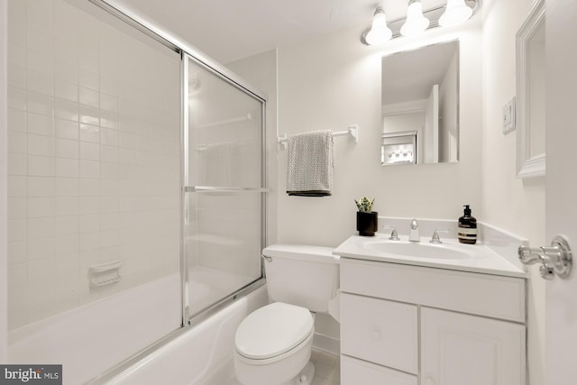 full bathroom with shower / bath combination with glass door, vanity, and toilet