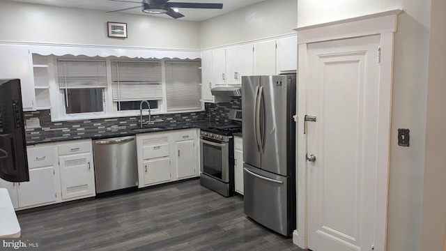 kitchen with dark hardwood / wood-style flooring, tasteful backsplash, stainless steel appliances, sink, and white cabinets