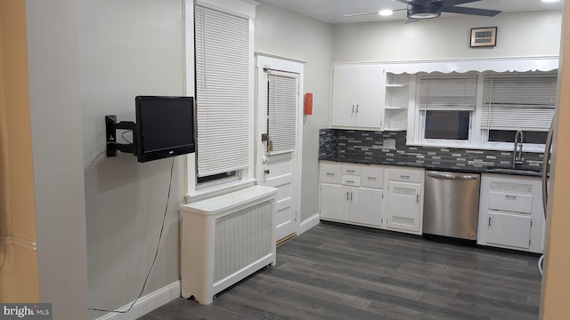 kitchen featuring decorative backsplash, dishwasher, radiator heating unit, dark hardwood / wood-style floors, and white cabinetry