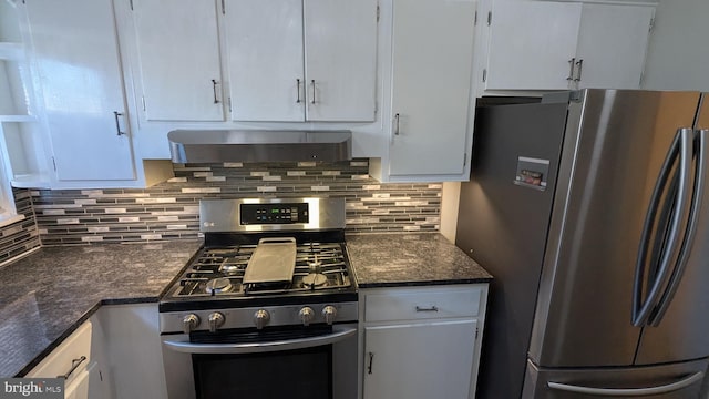 kitchen featuring white cabinets, stainless steel appliances, extractor fan, and tasteful backsplash