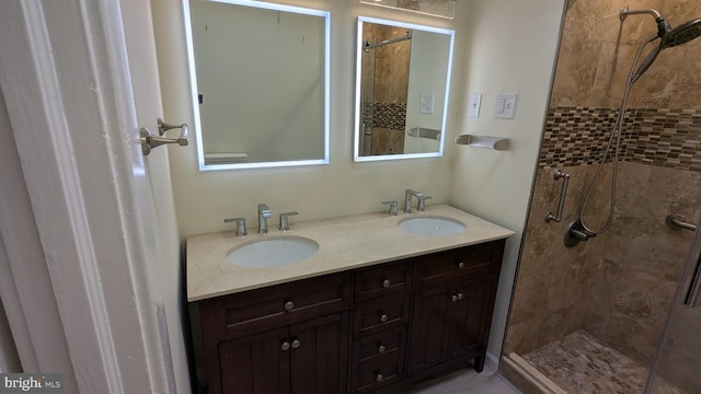 bathroom featuring vanity and tiled shower