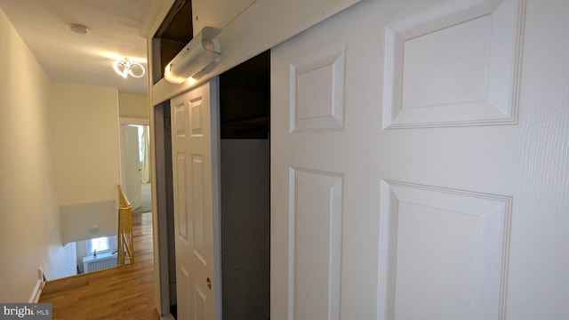 corridor with hardwood / wood-style floors